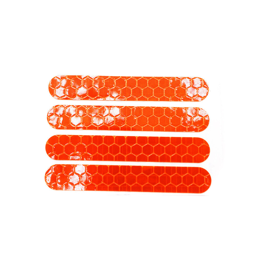Quatre stickers réfléchissants orange à motif en nid d'abeille