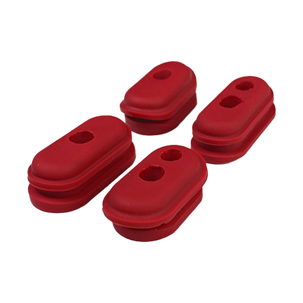 Lot de 4 bouchons de protection de câble en caoutchouc rouge posés sur fond blanc