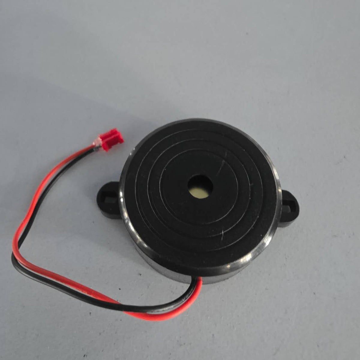 Buzzer rond noir avec câbles rouge et noir de trottinette électrique Dualtron Sonic Alien